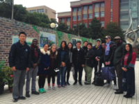 Choate students and faculty stand in front of Fudan High School.
